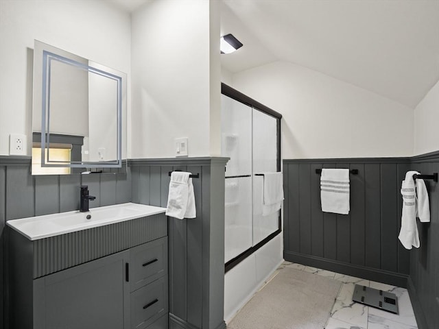 537 Milk St, Fitchburg, MA 01420 - full bath with marble look tile flooring, wainscoting, lofted ceiling, bath / shower combo with glass door, and vanity