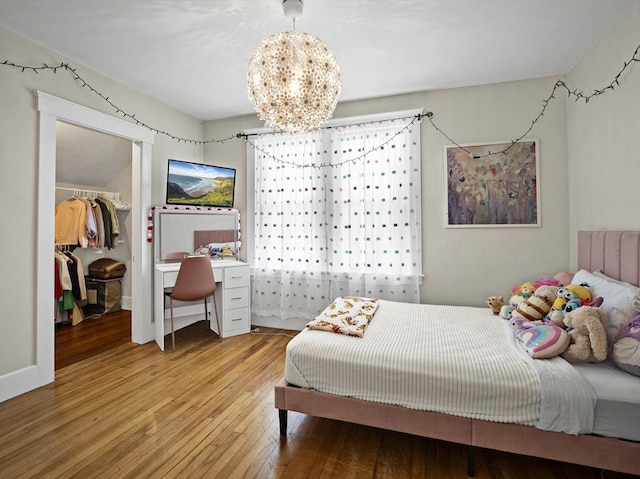 537 Milk St, Fitchburg, MA 01420 - bedroom featuring wood-type flooring, a walk in closet, a chandelier, and a closet