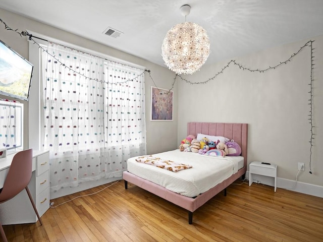 537 Milk St, Fitchburg, MA 01420 - bedroom with light wood-style flooring and a chandelier