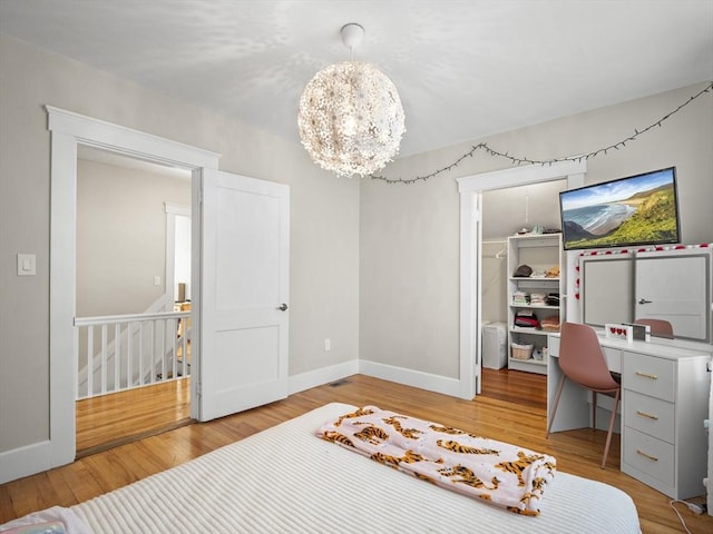 537 Milk St, Fitchburg, MA 01420 - bedroom with a spacious closet, light wood-style flooring, baseboards, a chandelier, and a closet