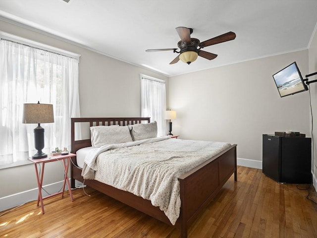 537 Milk St, Fitchburg, MA 01420 - bedroom featuring multiple windows, baseboards, hardwood / wood-style flooring, crown molding, and a ceiling fan