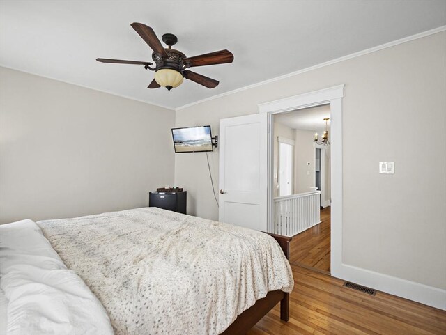 537 Milk St, Fitchburg, MA 01420 - bedroom with wood finished floors, a chandelier, baseboards, crown molding, and ceiling fan