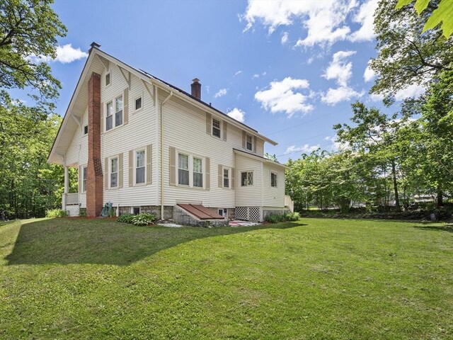 537 Milk St, Fitchburg, MA 01420 - rear view of house with a chimney and a yard