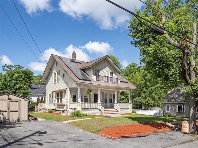 537 Milk St, Fitchburg, MA 01420 - view of front of property featuring covered porch, a chimney, roof mounted solar panels, a front yard, and roof with shingles