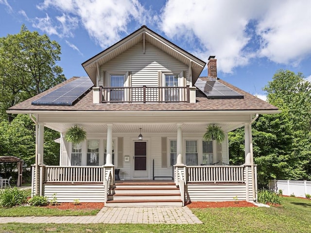 537 Milk St, Fitchburg, MA 01420 - bungalow-style home with covered porch, roof with shingles, and roof mounted solar panels