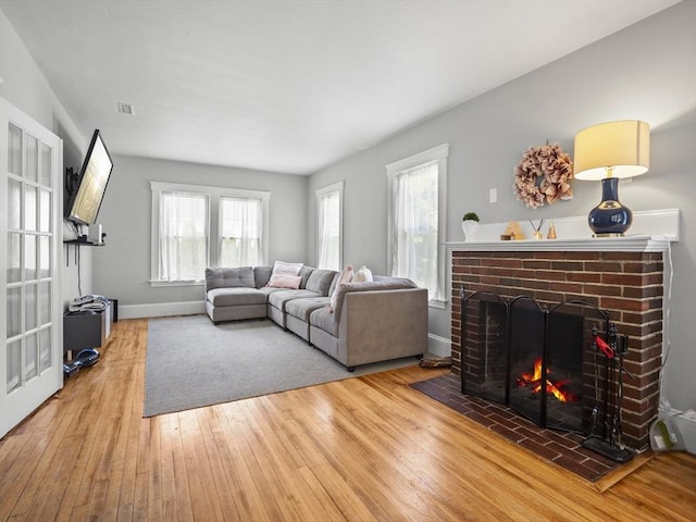 537 Milk St, Fitchburg, MA 01420 - living area featuring wood finished floors, a fireplace, and baseboards