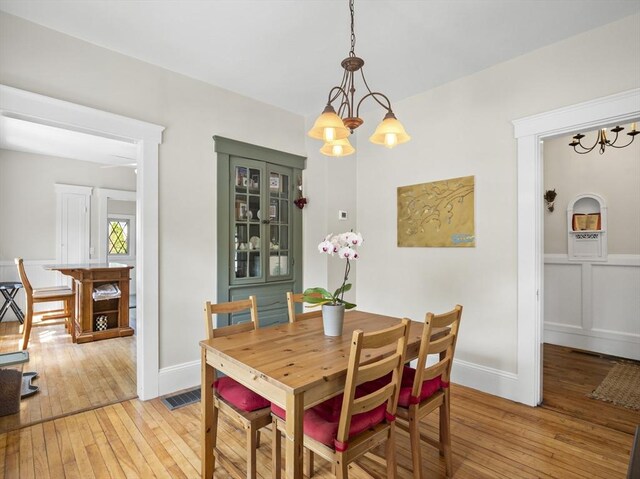 537 Milk St, Fitchburg, MA 01420 - dining room featuring light wood finished floors, a chandelier, and baseboards