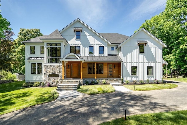 10 Fairlawn Ln, Lexington, MA 02420 - modern farmhouse style home with a standing seam roof, board and batten siding, a shingled roof, metal roof, and a porch