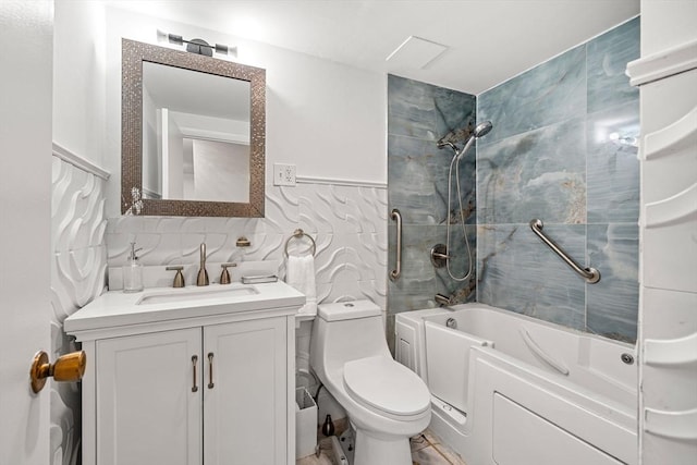 bathroom featuring vanity, tile walls, toilet, and washtub / shower combination