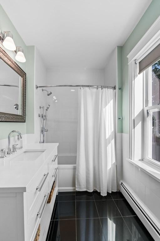 full bathroom with vanity, shower / tub combo, baseboard heating, and tile patterned flooring