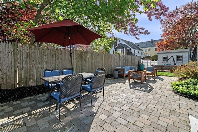 view of patio with a fenced backyard, an outdoor hangout area, and outdoor dining space