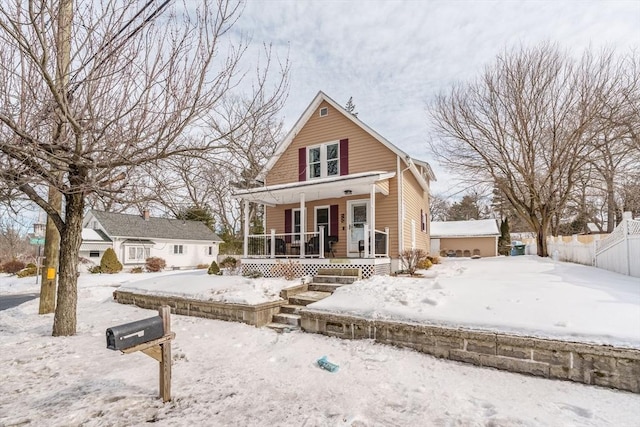 view of front of home featuring a porch and fence