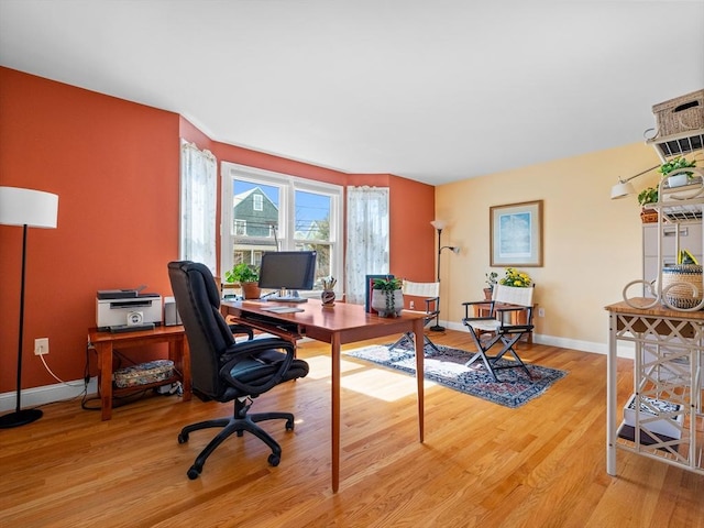 office area with baseboards and wood finished floors