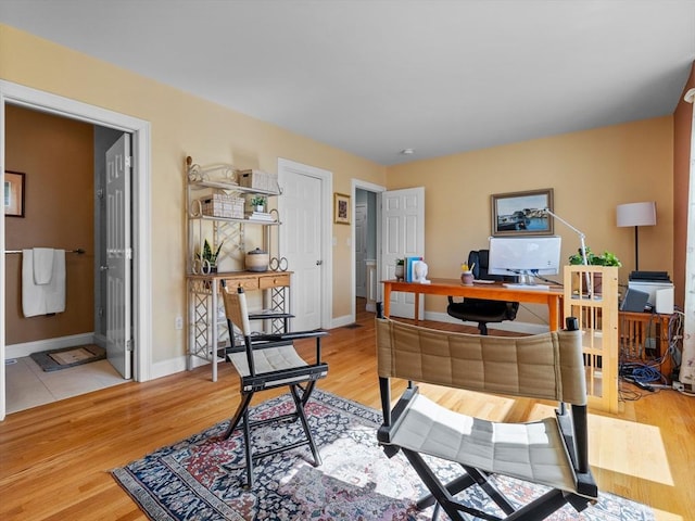 office with baseboards and wood finished floors