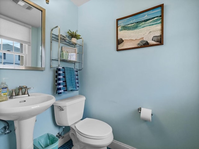 bathroom featuring visible vents, toilet, and baseboards