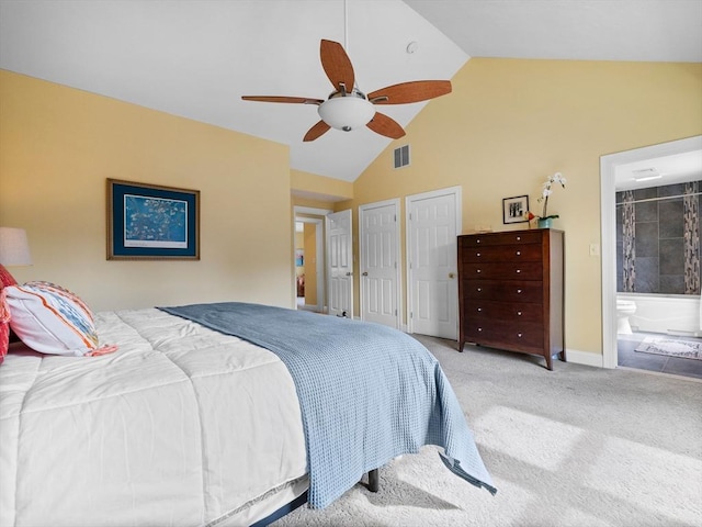 carpeted bedroom with visible vents, two closets, ensuite bath, baseboards, and ceiling fan