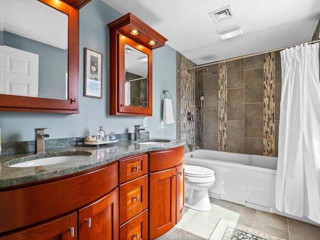 full bath with double vanity, toilet, visible vents, and a sink