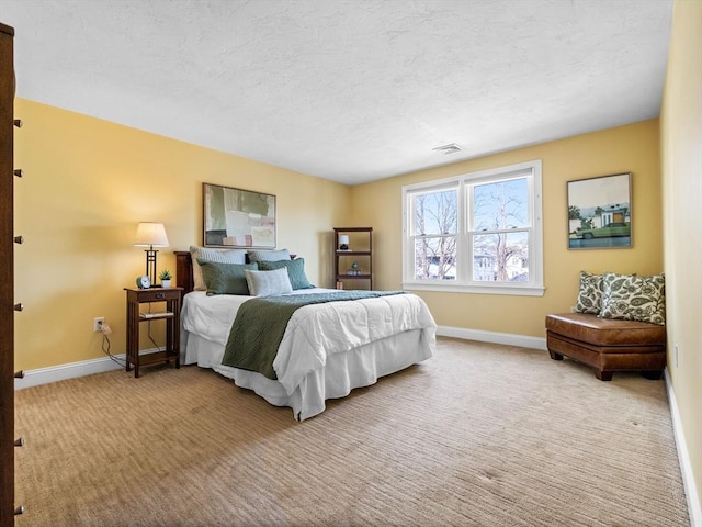 carpeted bedroom featuring visible vents, a textured ceiling, and baseboards