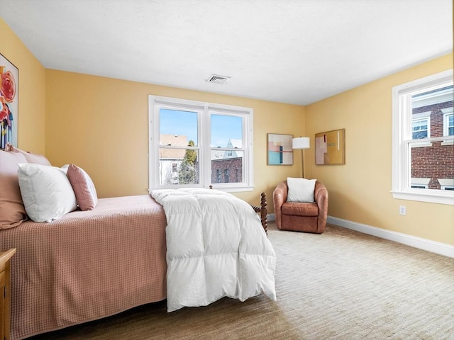 bedroom featuring baseboards, visible vents, multiple windows, and carpet floors