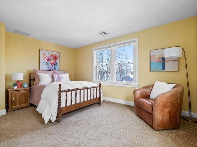 carpeted bedroom featuring visible vents and baseboards