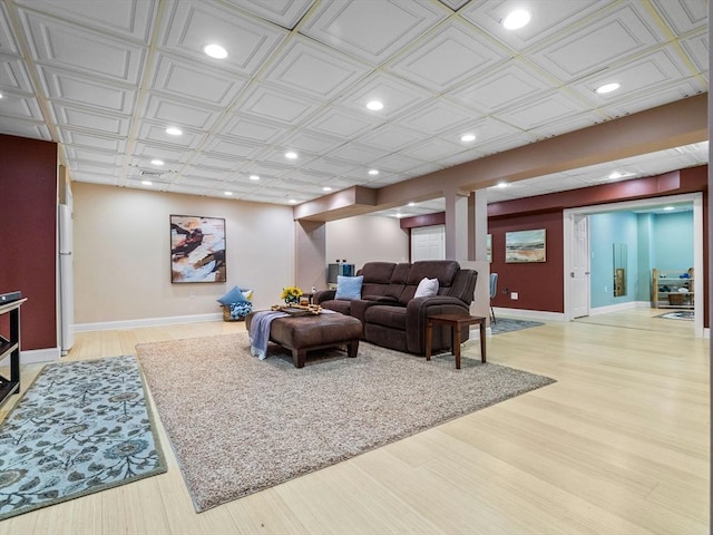 living room with an ornate ceiling, recessed lighting, baseboards, and light wood finished floors