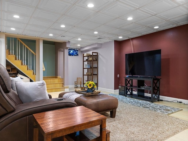 living area featuring recessed lighting, baseboards, wood finished floors, and stairs