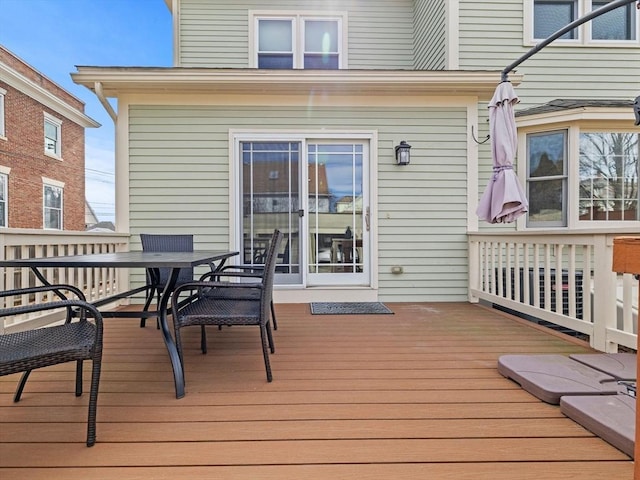 wooden terrace featuring outdoor dining area