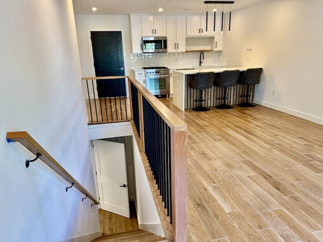 252 Main St Unit 101, Medford, MA 02155 - stairs with wood finished floors and baseboards