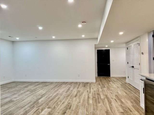 252 Main St Unit 101, Medford, MA 02155 - unfurnished room featuring wine cooler, light wood-style floors, baseboards, recessed lighting, and a smoke detector