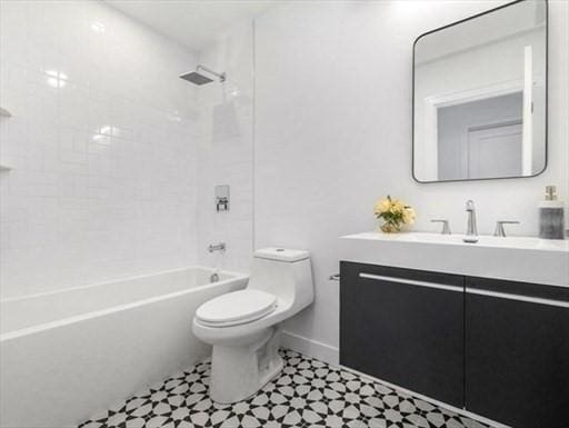 252 Main St Unit 101, Medford, MA 02155 - full bathroom featuring toilet, vanity, shower / bath combination, and baseboards