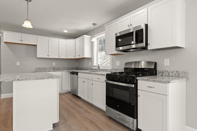 kitchen with white cabinetry, light wood-style flooring, appliances with stainless steel finishes, and a sink