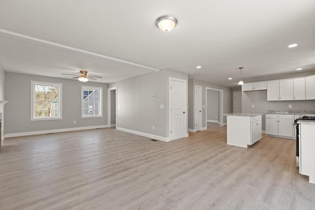 unfurnished living room with visible vents, a ceiling fan, recessed lighting, light wood finished floors, and baseboards
