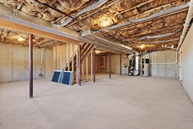 unfinished below grade area with heating unit and heat pump water heater