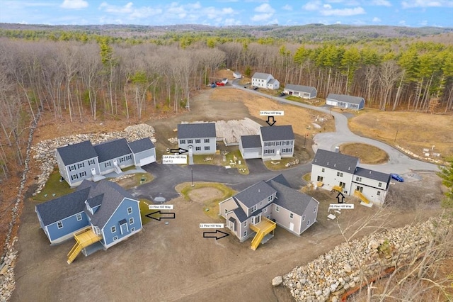 birds eye view of property with a forest view