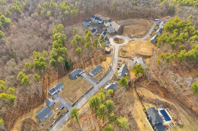 drone / aerial view featuring a wooded view