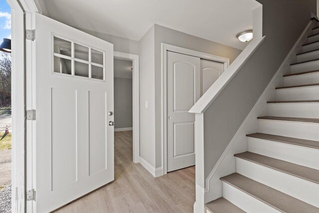 stairway with baseboards and wood finished floors