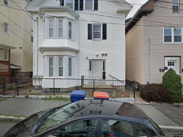 view of front facade with fence private yard