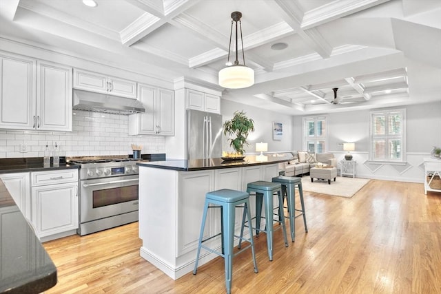 49 Baldwin St Unit 1, Boston, MA 02129 - kitchen with under cabinet range hood, stainless steel appliances, a ceiling fan, coffered ceiling, and open floor plan