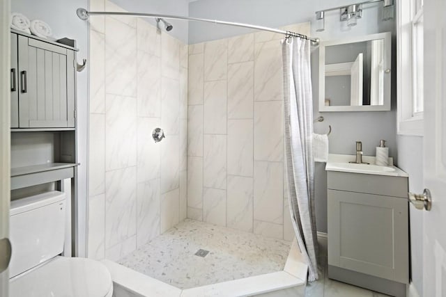 full bath with toilet, a stall shower, and vanity