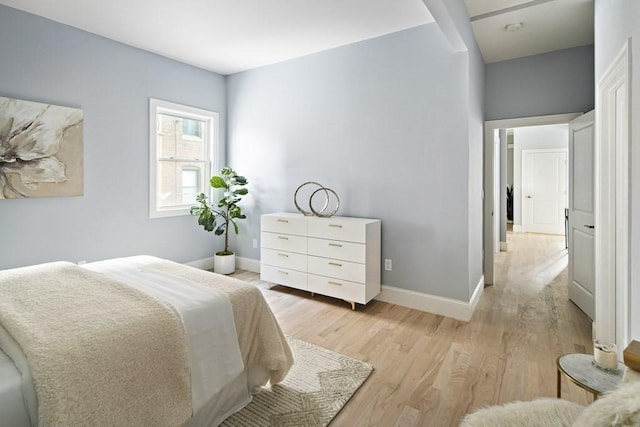 bedroom featuring baseboards and light wood-style floors