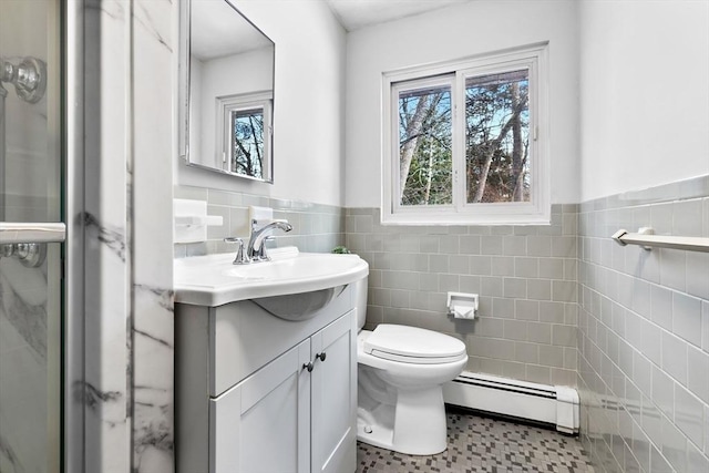 bathroom with vanity, a wealth of natural light, baseboard heating, and toilet