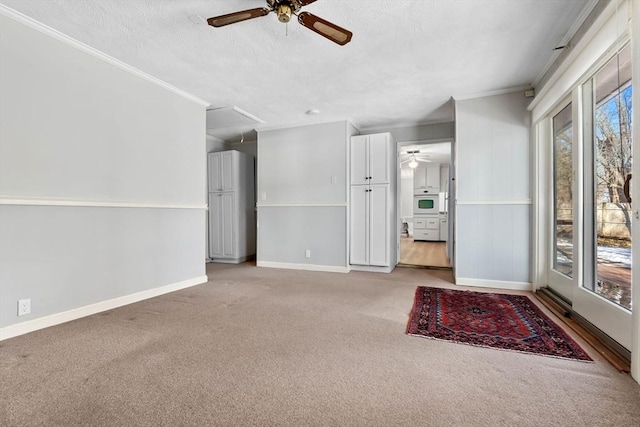 unfurnished living room featuring crown molding, light carpet, a textured ceiling, and ceiling fan