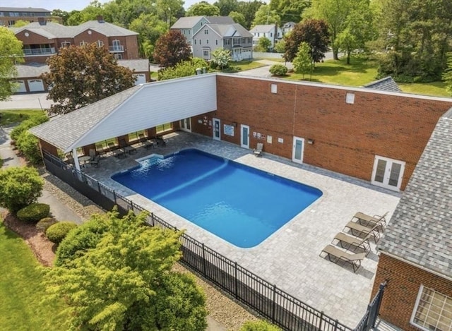 community pool featuring a gazebo, fence, and a residential view