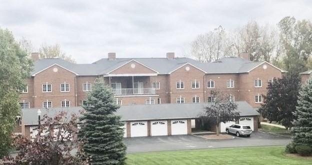 exterior space with an attached garage and aphalt driveway