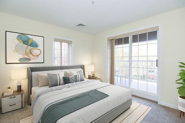 bedroom featuring multiple windows, carpet flooring, access to outside, and visible vents