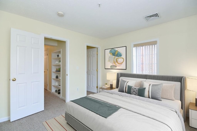 bedroom featuring baseboards, visible vents, and carpet