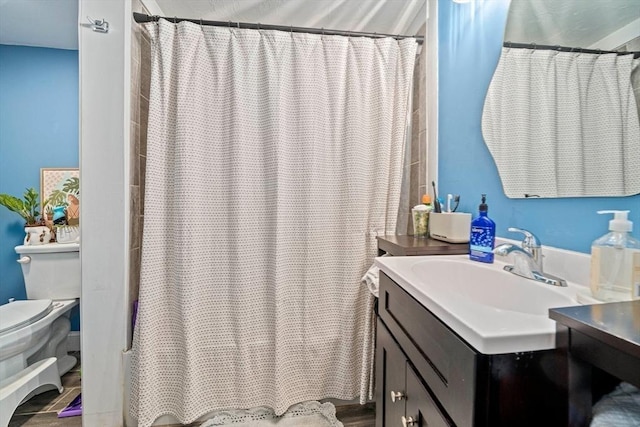 bathroom featuring vanity, toilet, and curtained shower