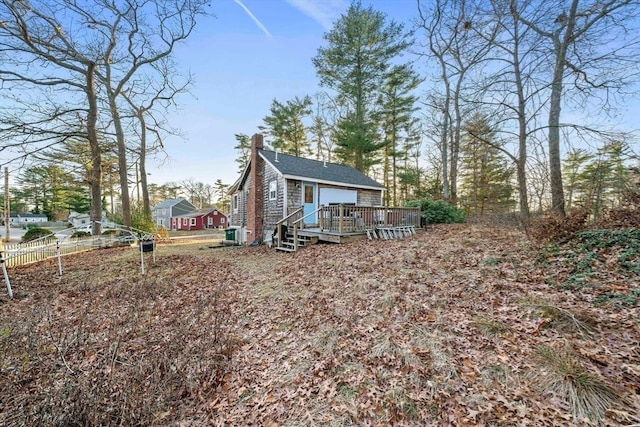 rear view of house with a wooden deck