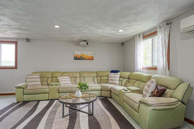 carpeted living room with plenty of natural light, a wall mounted AC, recessed lighting, baseboards, and a textured ceiling