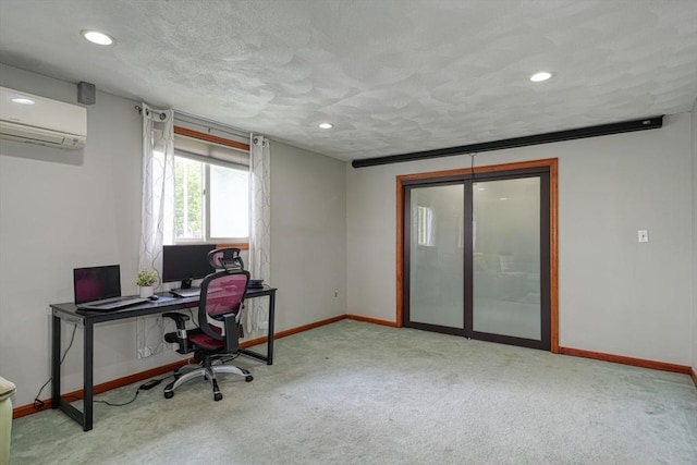 carpeted home office with a wall mounted air conditioner, baseboards, recessed lighting, and a textured ceiling